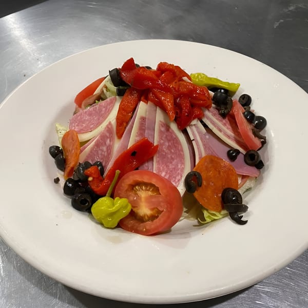 Pastafina's Italian antipasto salad with salami, pepperoni, cheese, olives, tomatoes, and peppers.