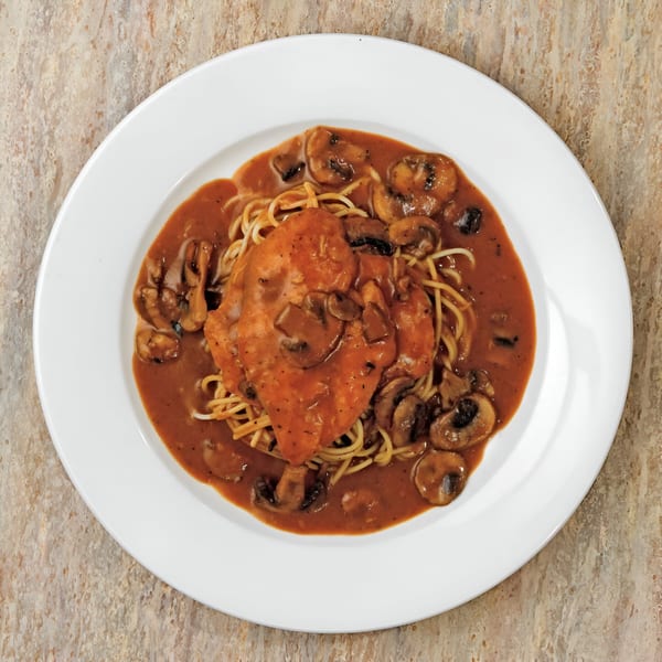 Pastafina's chicken marsala with spaghetti and mushrooms in a rich brown sauce.