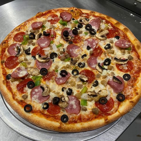 A Pastafina pizza with pepperoni, salami, mushrooms, olives, onions, and green peppers.